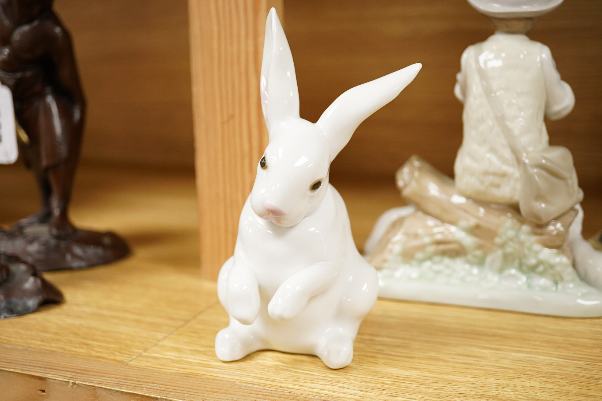 Four Lladro and Nao figures and a Doulton Toby jug, The Lawyer, largest 20cm high